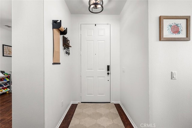 doorway featuring dark wood-type flooring