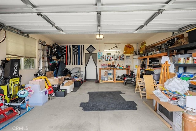 garage with a garage door opener and a workshop area