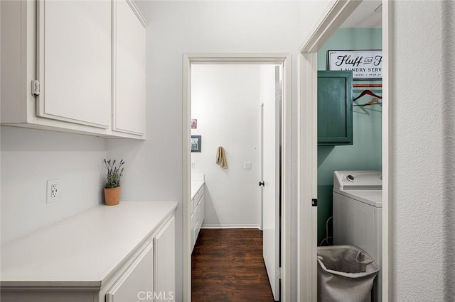 washroom featuring washer / dryer, dark wood-type flooring, and cabinets