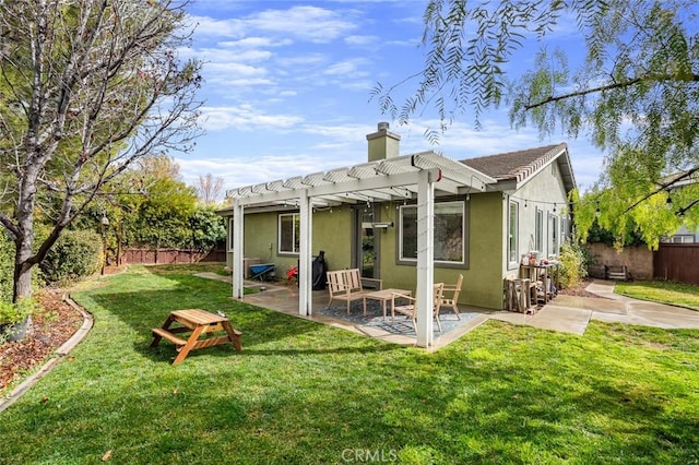 rear view of house with a pergola, a patio area, and a lawn