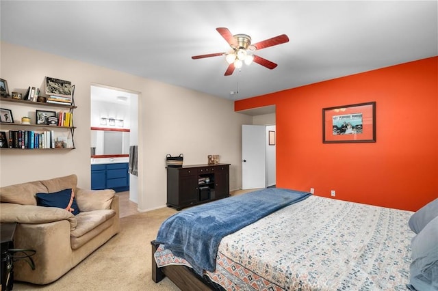 bedroom with light carpet, ensuite bath, and ceiling fan