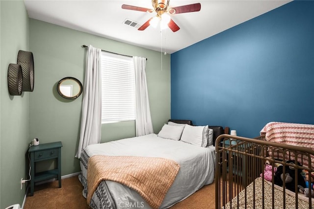 bedroom featuring ceiling fan and dark carpet