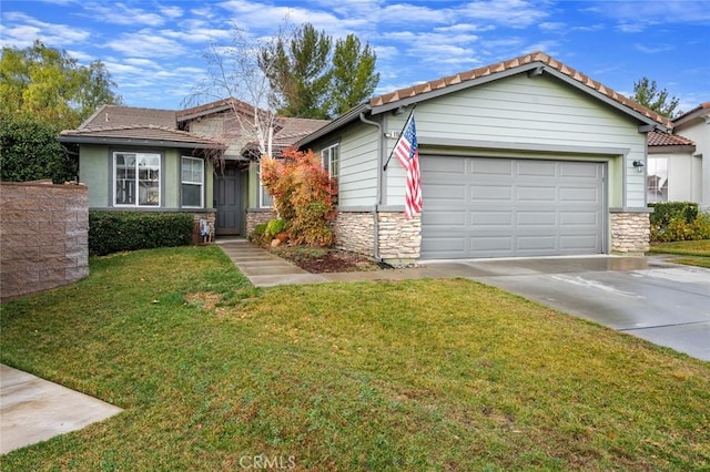 view of front of property featuring a garage and a front lawn