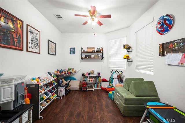 game room featuring dark hardwood / wood-style flooring and ceiling fan