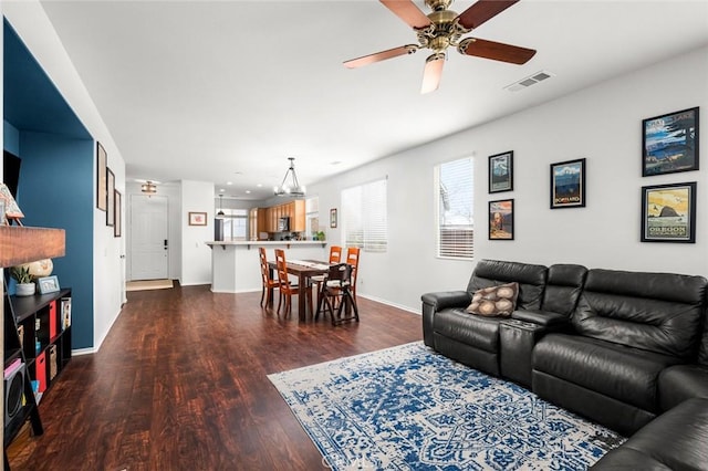 living room with dark hardwood / wood-style floors and ceiling fan