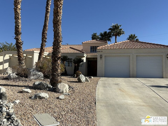 mediterranean / spanish home with a garage