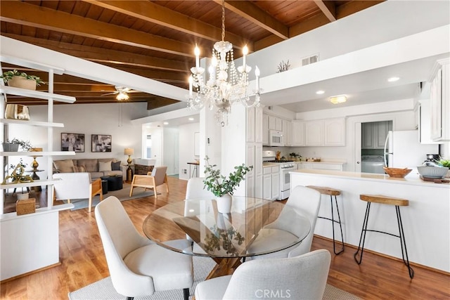 dining area featuring beamed ceiling, ceiling fan with notable chandelier, wood ceiling, and light hardwood / wood-style flooring