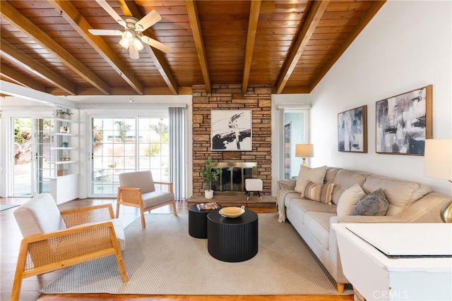 living room featuring ceiling fan, light wood-type flooring, wood ceiling, and a fireplace