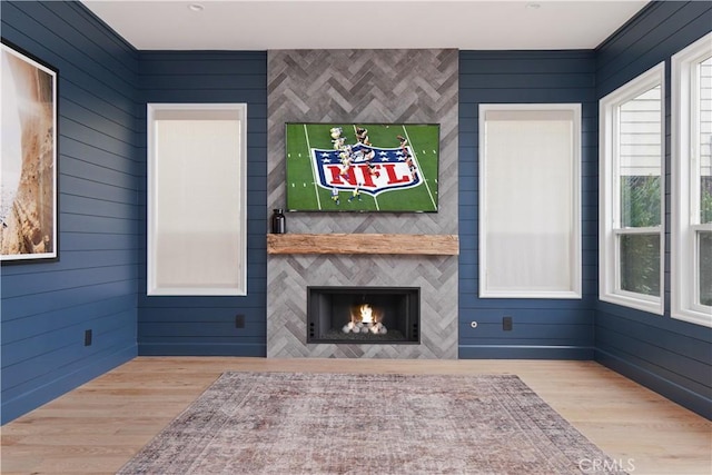 unfurnished living room featuring a fireplace and light wood-type flooring