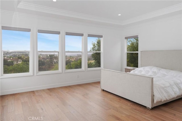 bedroom with crown molding and light hardwood / wood-style flooring