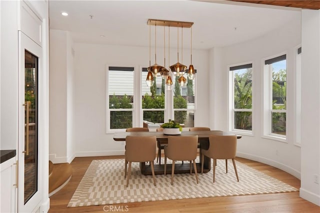 dining area featuring a chandelier and light wood-type flooring