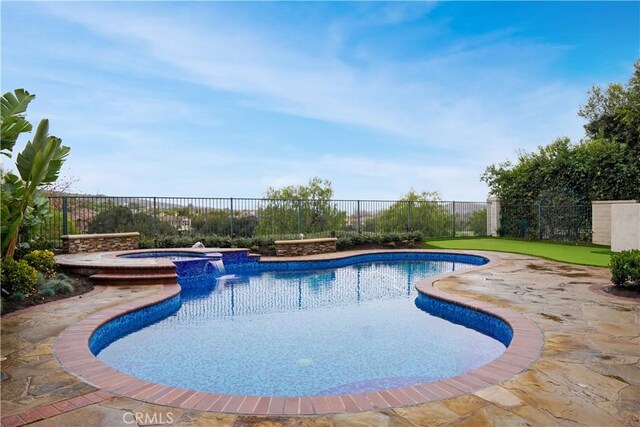 view of pool with a patio area and an in ground hot tub