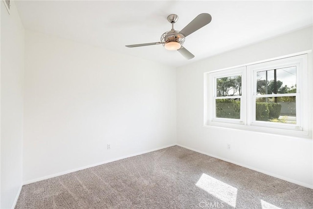 carpeted spare room with ceiling fan