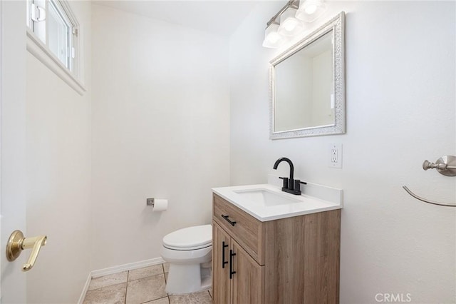 bathroom featuring vanity, toilet, and tile patterned flooring