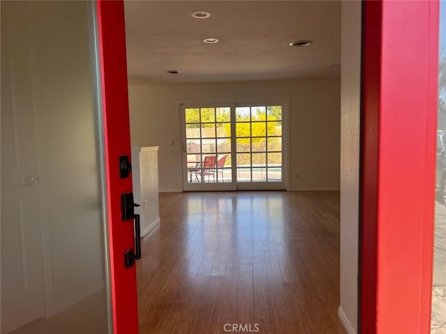 unfurnished room with wood-type flooring