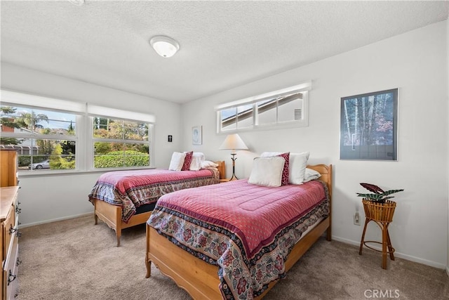 carpeted bedroom featuring a textured ceiling