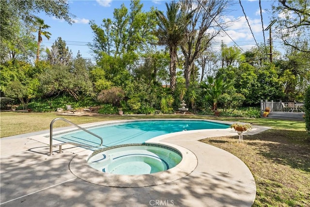 view of pool with a yard, a patio area, and an in ground hot tub