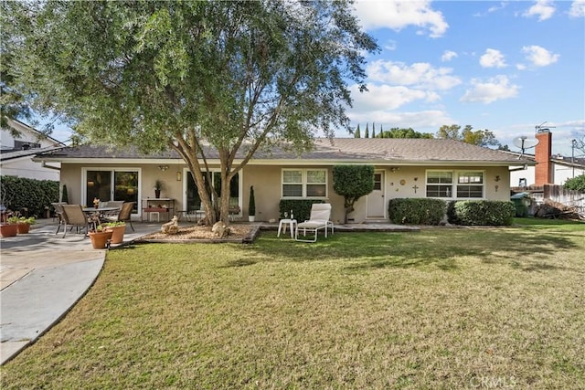 back of property featuring a yard and a patio area