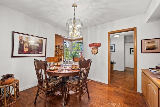 dining area featuring an inviting chandelier and dark hardwood / wood-style floors