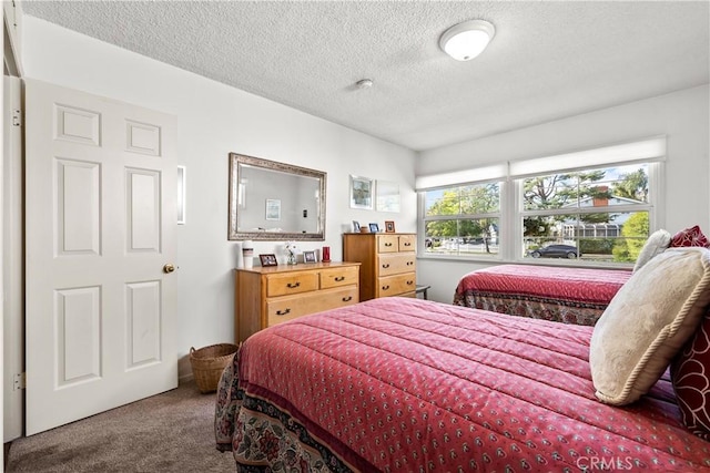 carpeted bedroom featuring a textured ceiling