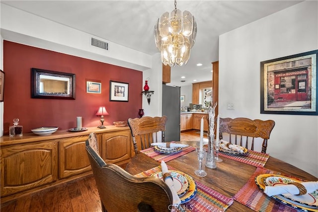 dining room with a notable chandelier and hardwood / wood-style floors