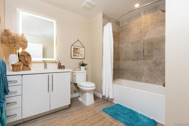 full bathroom featuring vanity, wood-type flooring, toilet, and shower / bath combo with shower curtain