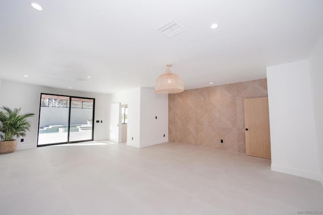 empty room featuring tile walls