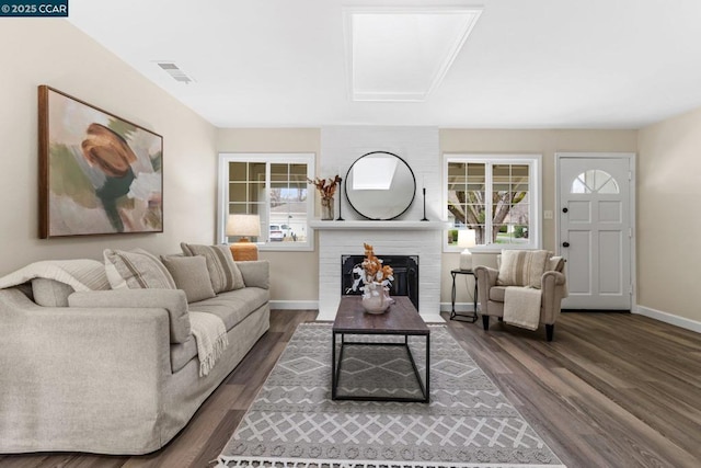 living room featuring a fireplace and dark hardwood / wood-style floors