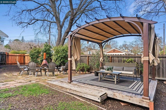 exterior space featuring an outdoor living space with a fire pit and a pergola