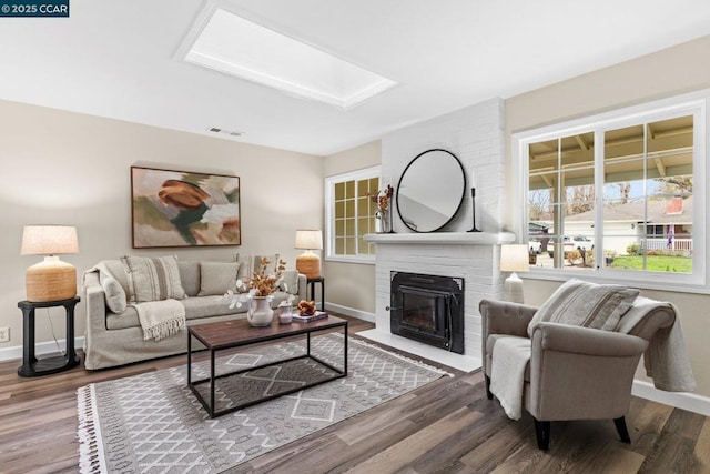 living room with a fireplace and hardwood / wood-style floors