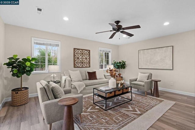 living room featuring ceiling fan and light hardwood / wood-style flooring