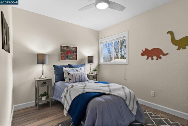 bedroom featuring dark hardwood / wood-style flooring and ceiling fan