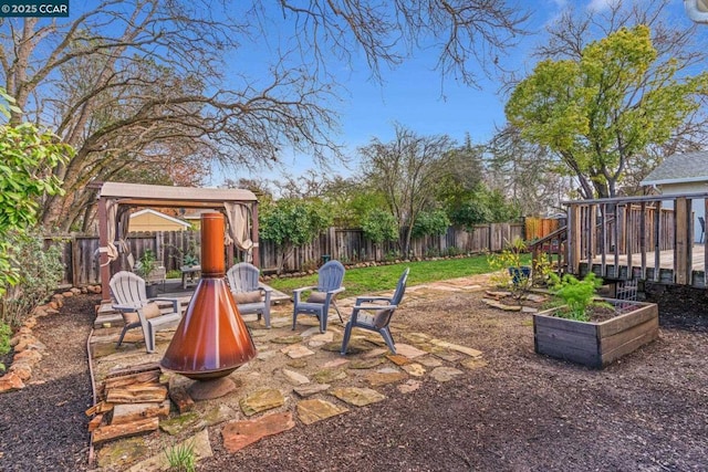 view of yard featuring a wooden deck and a fire pit