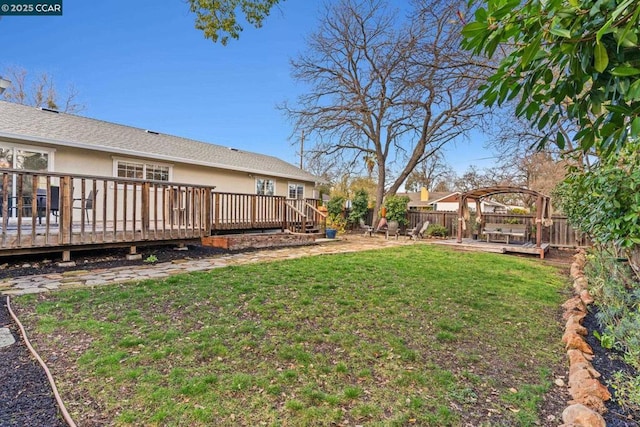 view of yard featuring a wooden deck and a pergola