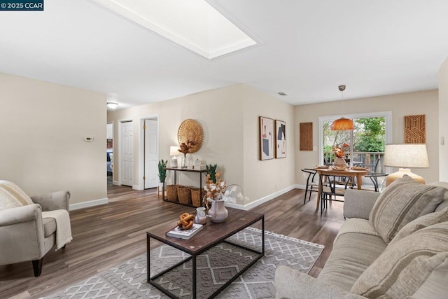 living room featuring dark hardwood / wood-style floors and a skylight