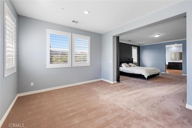 unfurnished bedroom featuring ornamental molding and carpet