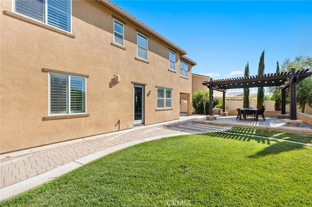 back of house with a yard, a pergola, and a patio area