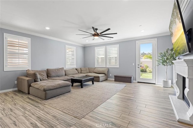 living room with light hardwood / wood-style flooring, ornamental molding, and ceiling fan