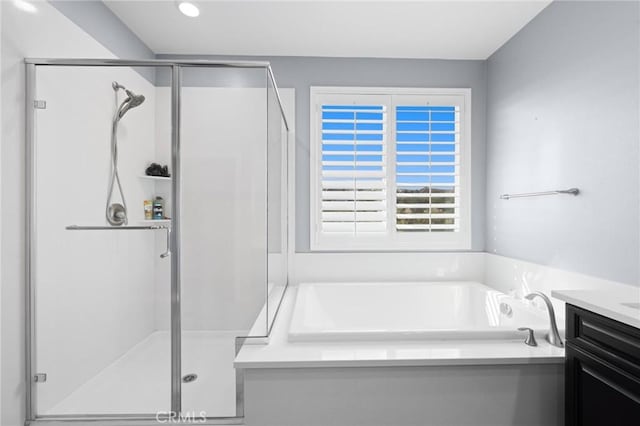 bathroom featuring vanity and plus walk in shower