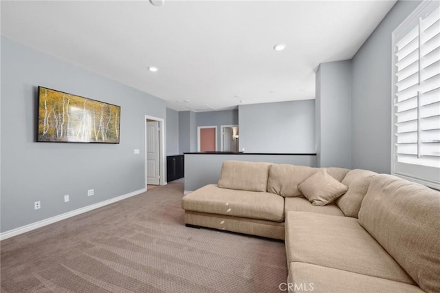 living room featuring light carpet and a healthy amount of sunlight