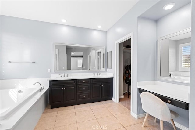 bathroom featuring a tub to relax in, vanity, and tile patterned flooring