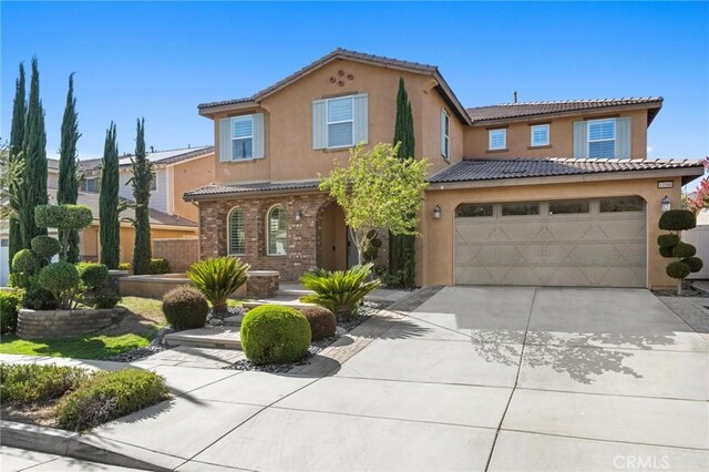 mediterranean / spanish-style home featuring a garage