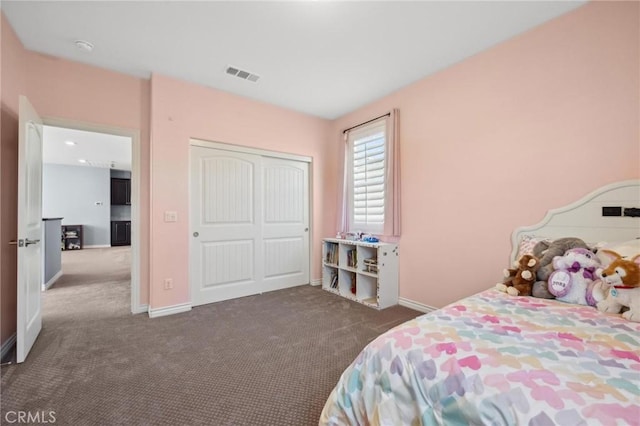 bedroom featuring dark colored carpet and a closet