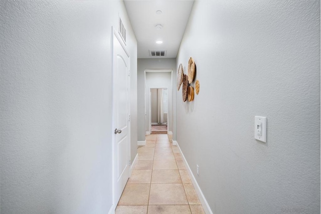 hallway featuring light tile patterned flooring