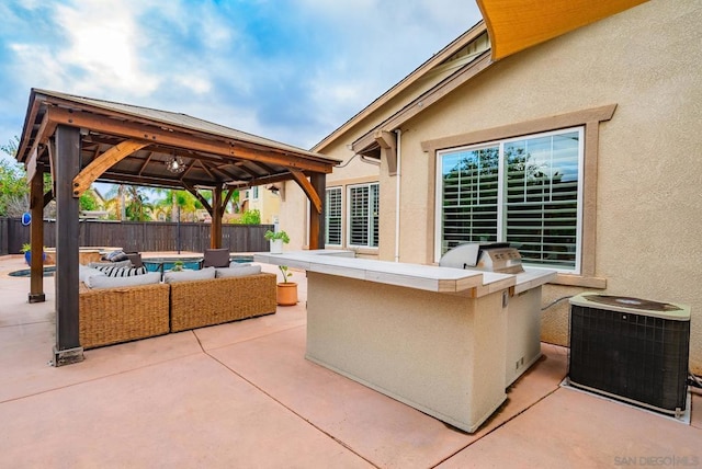 view of patio featuring an outdoor living space, a gazebo, area for grilling, and central air condition unit