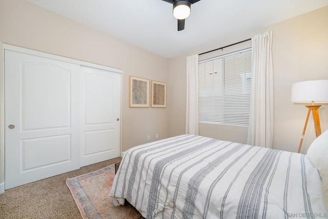 carpeted bedroom featuring ceiling fan and a closet