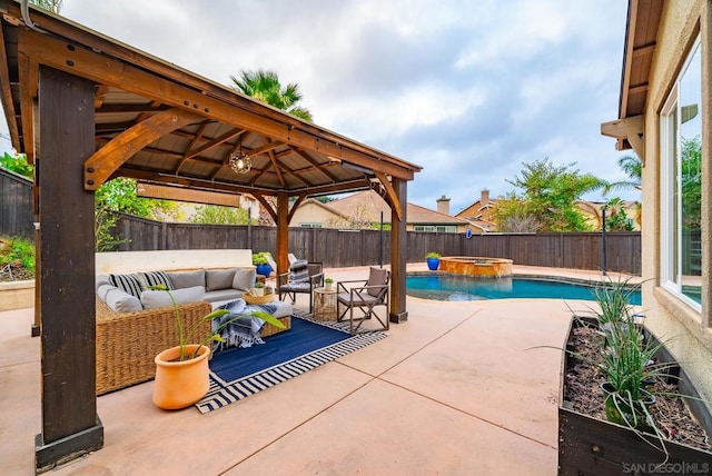 view of patio / terrace featuring a swimming pool with hot tub, a gazebo, and an outdoor hangout area