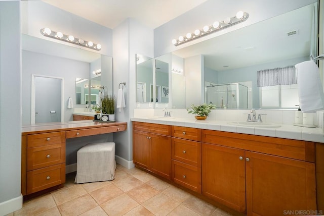 bathroom featuring vanity, tile patterned flooring, and a shower with door