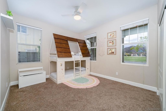 unfurnished office featuring ceiling fan and carpet