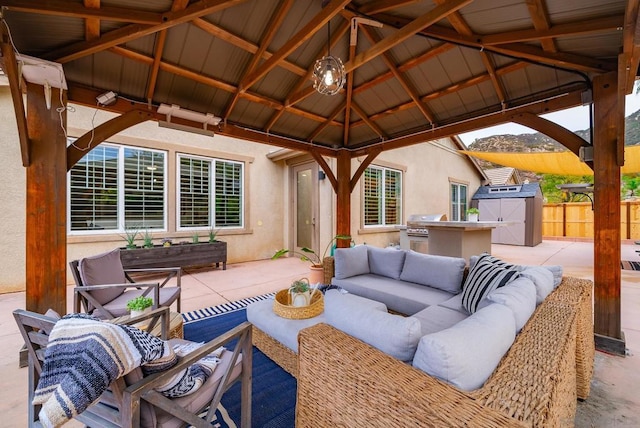 view of patio / terrace with exterior kitchen, a gazebo, outdoor lounge area, and area for grilling